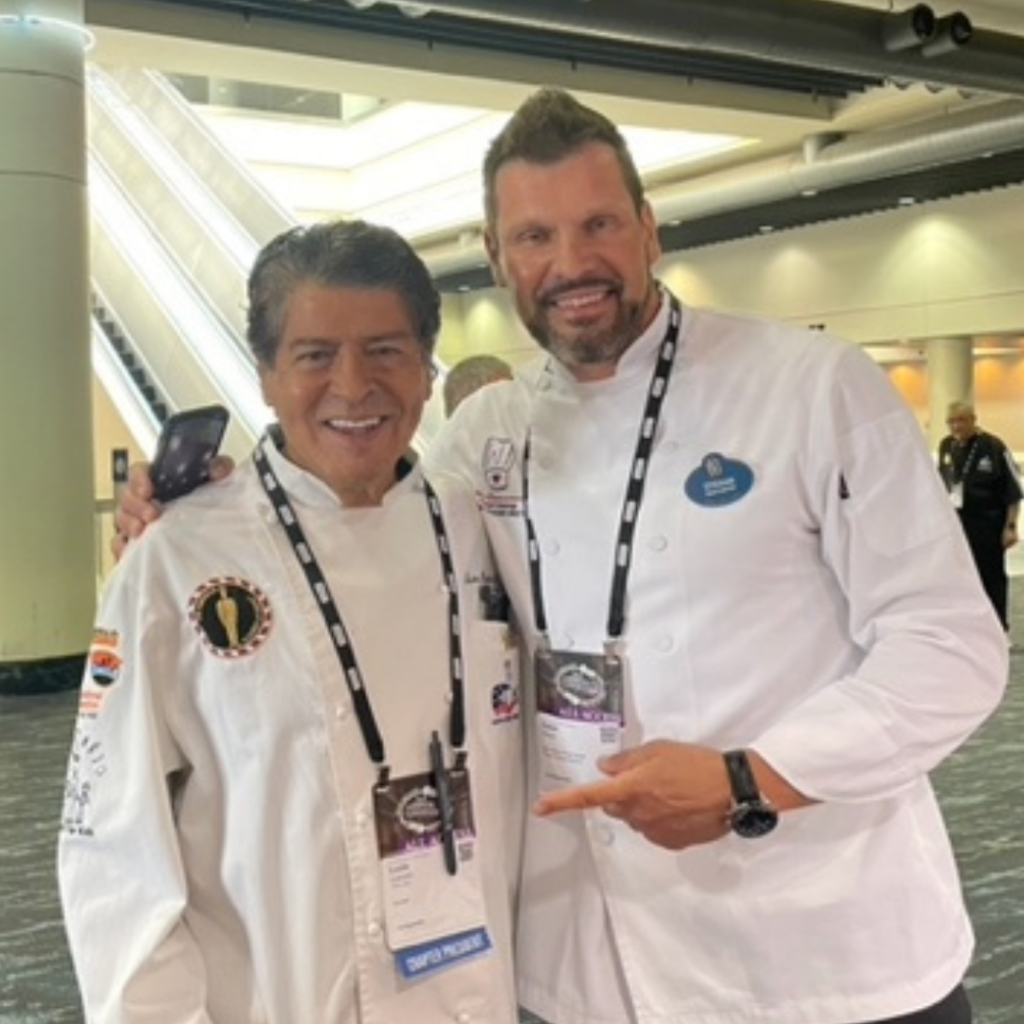 Chef Lucio Arancibia poses for a picture with Chef Stefan Riemer at ACF National Convention.