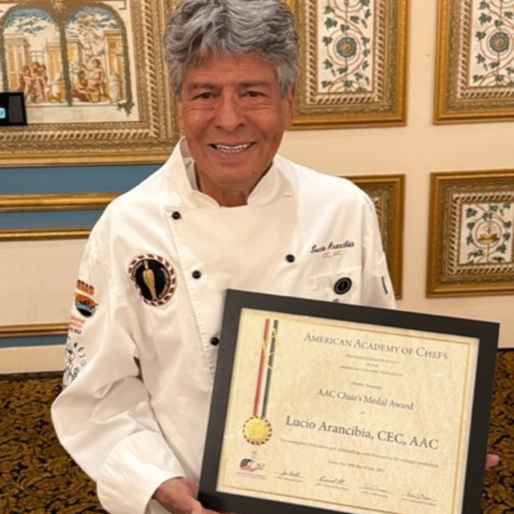 A man holds a framed certificate.